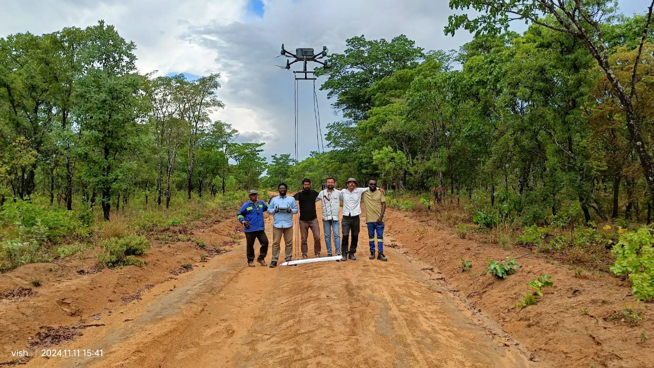 Survey team in the field with an airborne magnetometer system during training